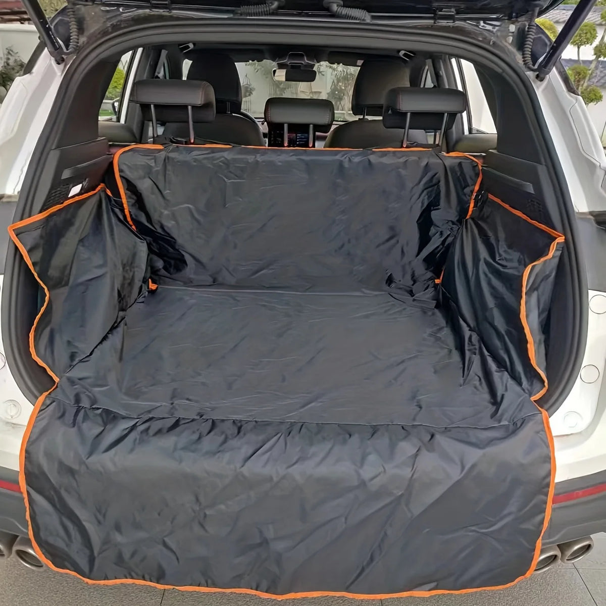 Black waterproof pet car seat cover laid out in the trunk of a white SUV.