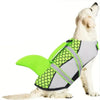A white dog wearing a bright lime green swimming life jacket for water activities.