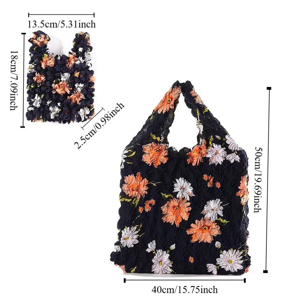 Black fabric reusable foldable bubble shopping bag with orange and white floral embroidery