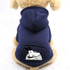 A navy blue cozy fleece dog sweatshirt with a hood and a pocket featuring a white face design.