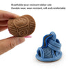 A pair of blue fabric dog and cat walking shoes is shown next to a brown rubber sole.