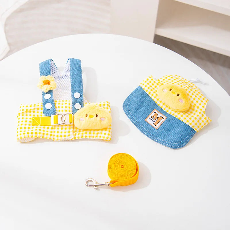Un ensemble de harnais pour chien et chat en tissu jaune et bleu avec une laisse assortie sur une table blanche.