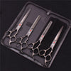 A set of professional stainless steel pet grooming scissors and combs stored in a dark zippered case.