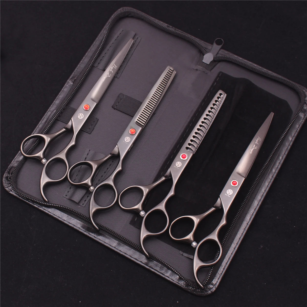 A set of professional stainless steel pet grooming scissors and combs stored in a dark zippered case.