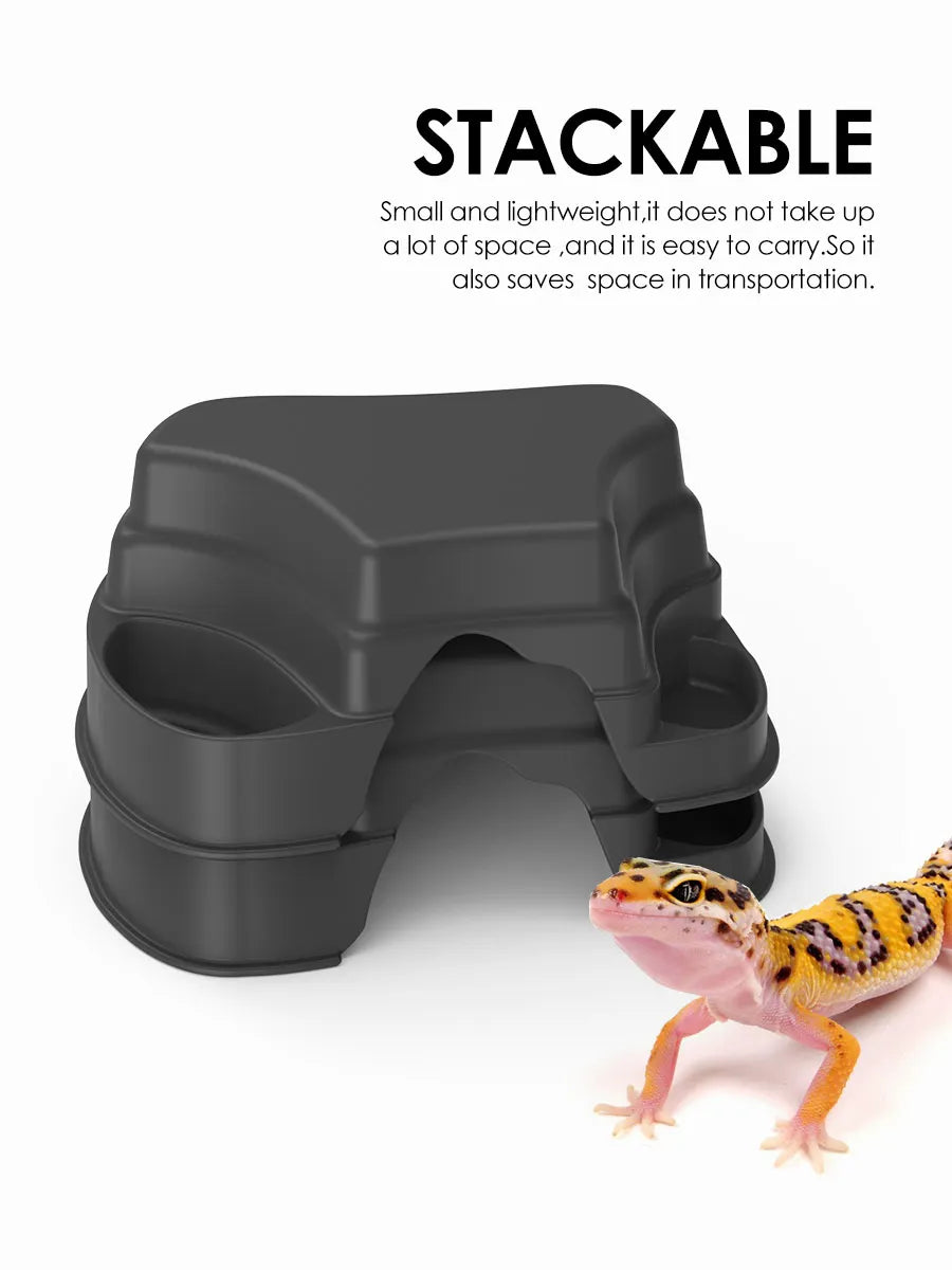 A dark gray, stackable reptile hide cave decoration with food bowls is shown next to a small lizard.
