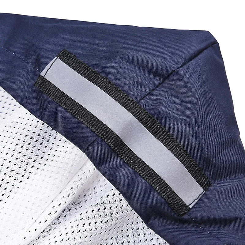 A close-up of a navy blue and white dog raincoat showing a gray reflective stripe detail.