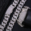 Silver glitter chain necklace with a curved flip buckle and Cuban links displayed on a black background.