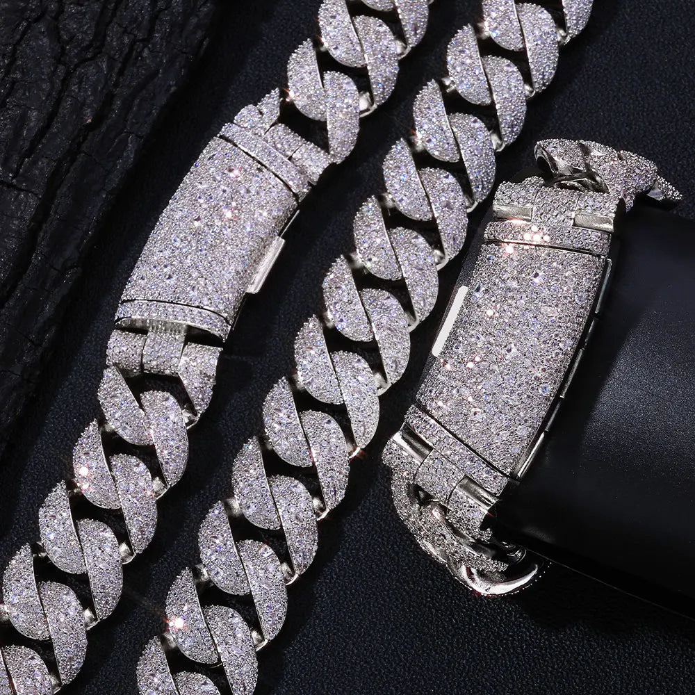 Silver glitter chain necklace with a curved flip buckle and Cuban links displayed on a black background.
