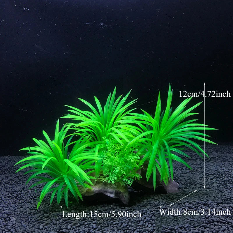 Un bouquet de plantes aquatiques artificielles vert vif aux feuilles longues et fines, exposées sur du gravier foncé.