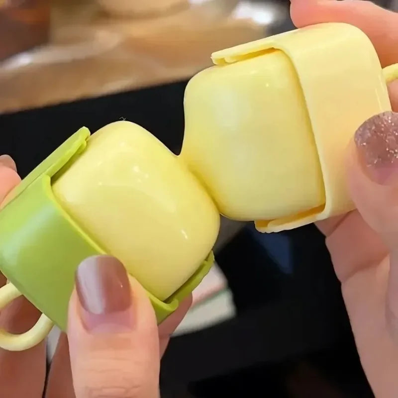 A hand holds a yellow portable lint roller with a green handle, showing the rolled-up lint removal pad.
