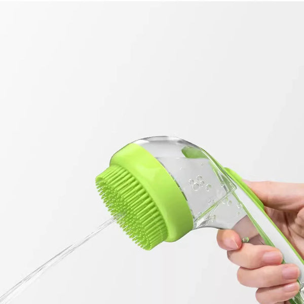 A hand is holding a clear pet bath brush with a bright lime green scrubbing head, dispensing water.