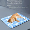 A blue pet cooling mat for dogs featuring illustrations of white and black animals.