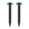 A pair of black ultrasonic pest repellers with green tops and pointed bottoms.