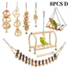 Eight pieces of natural wooden swing and chewing toys for parrots, including various shapes and sizes.