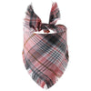 A plaid dog bandana featuring shades of pink, black, and brown with fringed edges.