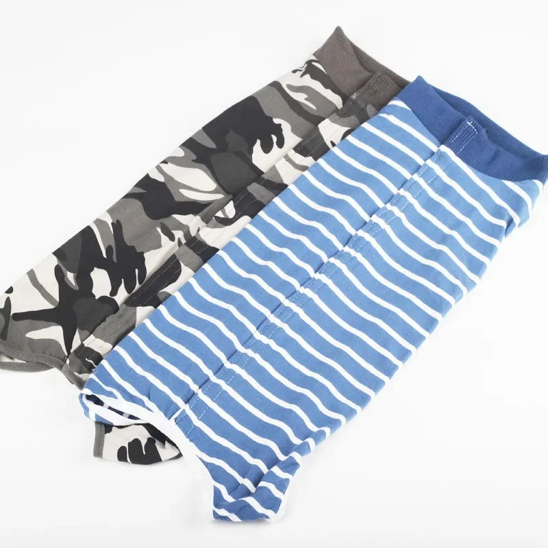 A stack of breathable pet recovery suits for dogs and cats in camouflage and blue stripes.