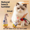 A fluffy gray and white cat is playing with a natural beech tumbler toy featuring a feather wobble ball.