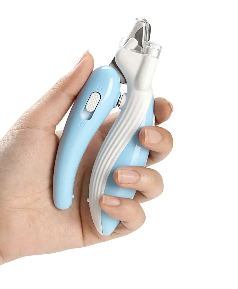 A hand holds a light blue professional pet nail clipper with a silver clamp and LED light feature.