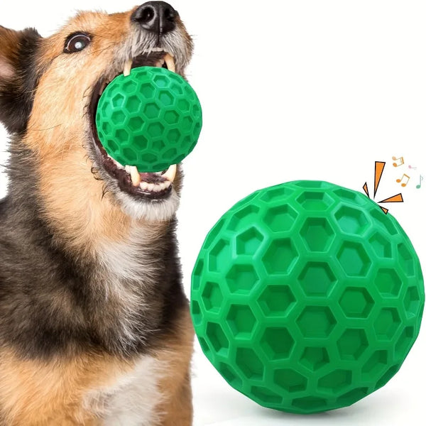 A dog is aggressively mouthing a bright green hexagonal squeaky toy.