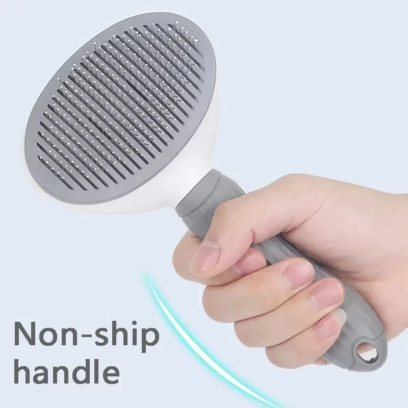 A hand holds a gray pet hair remover grooming brush with a non-ship handle.
