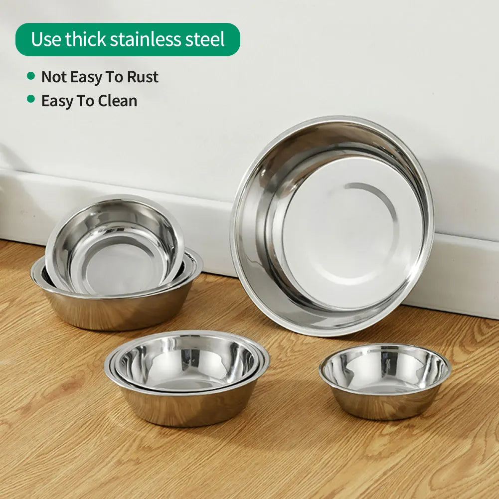 A set of stainless steel pet feeding bowls for dogs and cats displayed on a wooden surface.