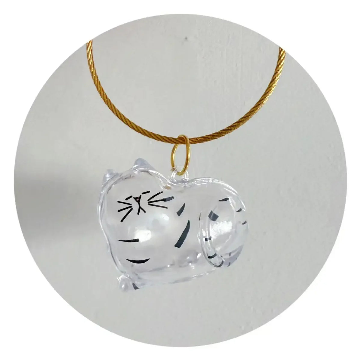Porte-clés en silicone en forme de cœur pour poils d'animaux, suspendu à une corde dorée.