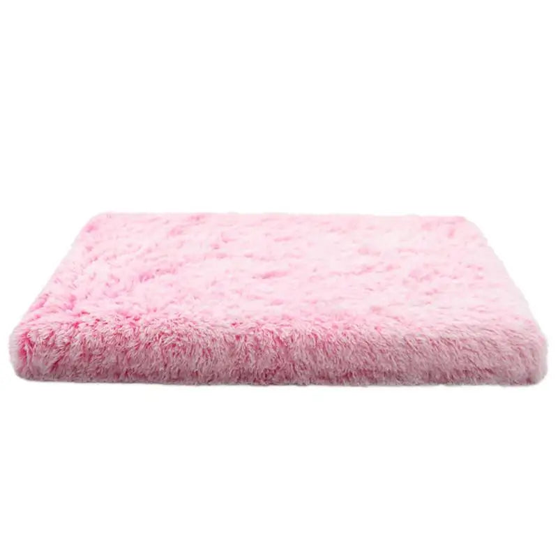 A rectangular pink ultra plush orthopedic dog bed with a fluffy texture.
