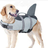A light-colored dog wearing a gray buoyancy life jacket with a fin for swimming.