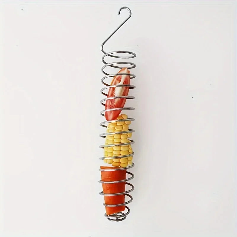 Stainless steel parrot feeder with a spiral basket holding various fruits and vegetables