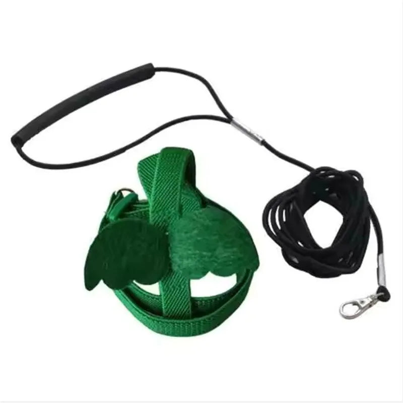 Green parrot bird harness and leash set with a black strap and clip.