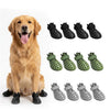 A golden retriever sits next to various black, green, and gray waterproof silicone pet rain boots for dogs.