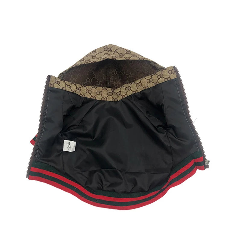 Black outerwear with a brown and gold patterned collar and red trim.