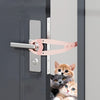 A pink adjustable pet door stopper is installed on a gray door, with a kitten looking out from the gap.