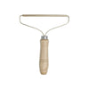A manual lint remover brush with a wooden handle and metal wire frame.