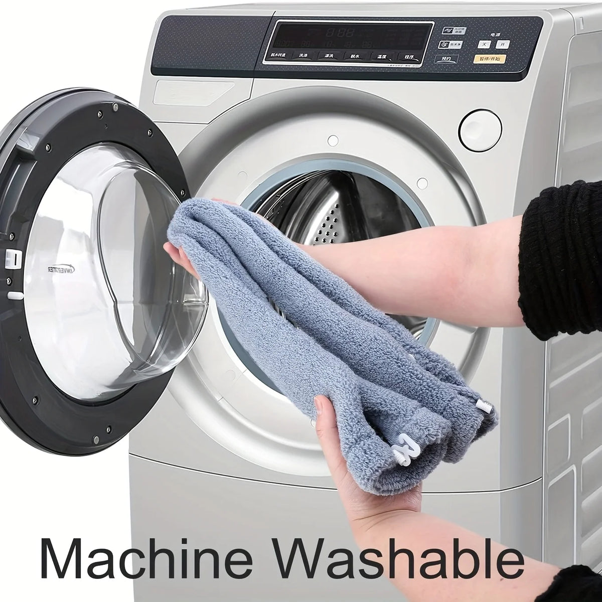A hand is placing a gray plush non-slip toilet seat cover onto the interior of a washing machine.