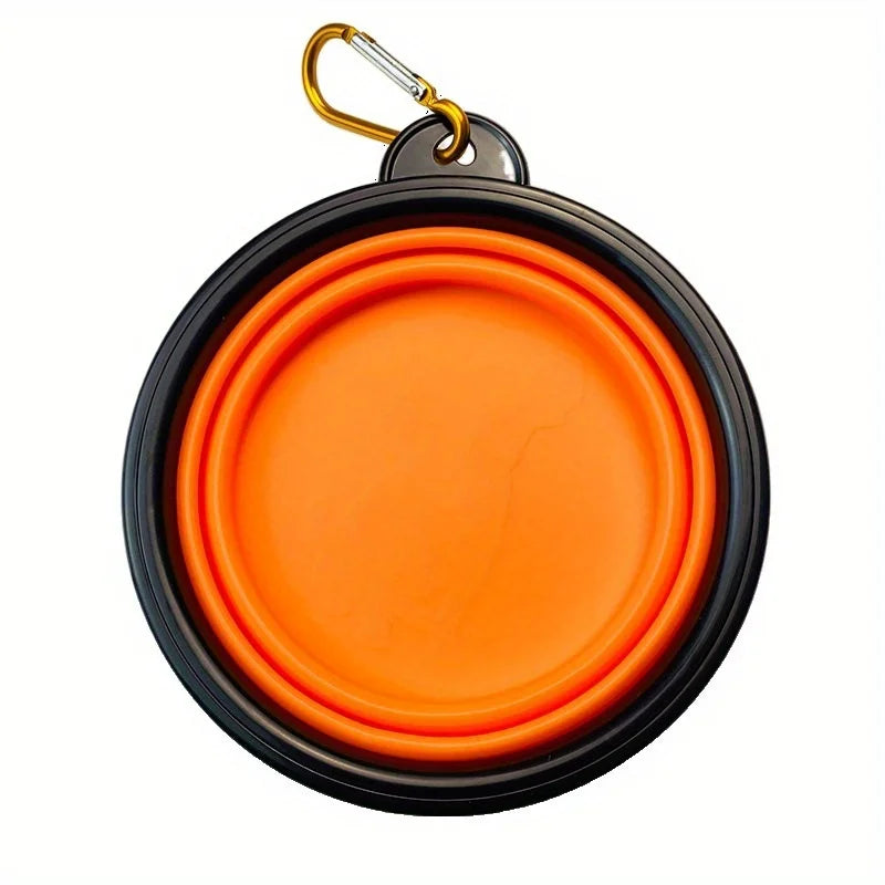A round orange silicone dog travel bowl with a metal keyring attached.