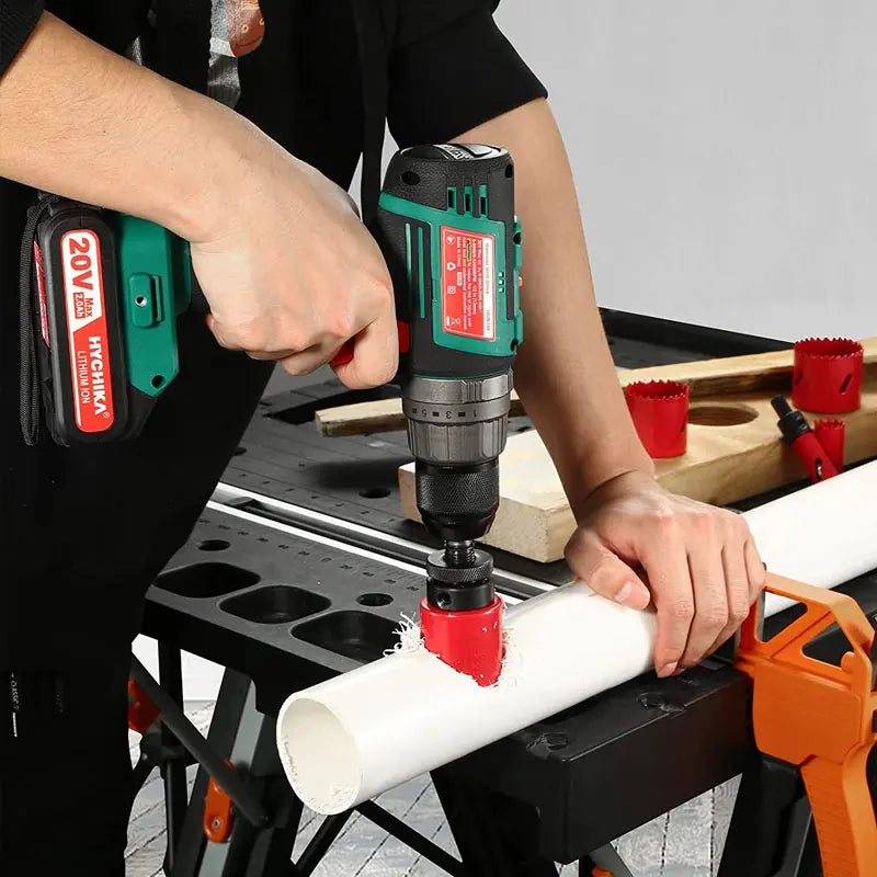 A person is using a power drill to create holes in a white cylindrical object, demonstrating a bi-metal hole saw kit.