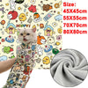 A close-up of a cat wearing a colorful self-adhesive pet swaddle wrap against a background of cute doodles.