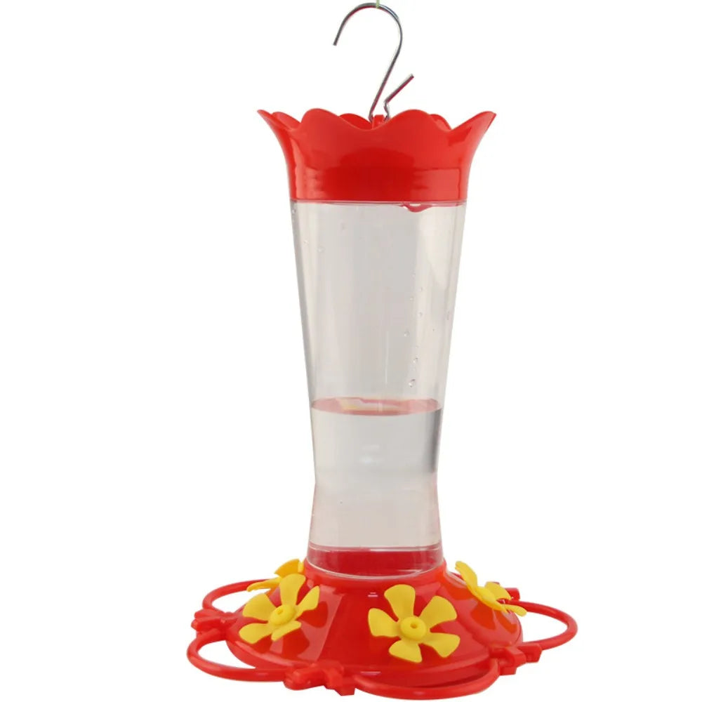 Comedero de colibrí rojo suspendido con tubo transparente y base de flor amarilla
