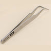A pair of silver precision tweezers used for handling small beads.