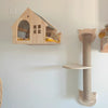 A wooden wall mounted cat climbing shelf featuring an arched entrance and a bridge for cats.