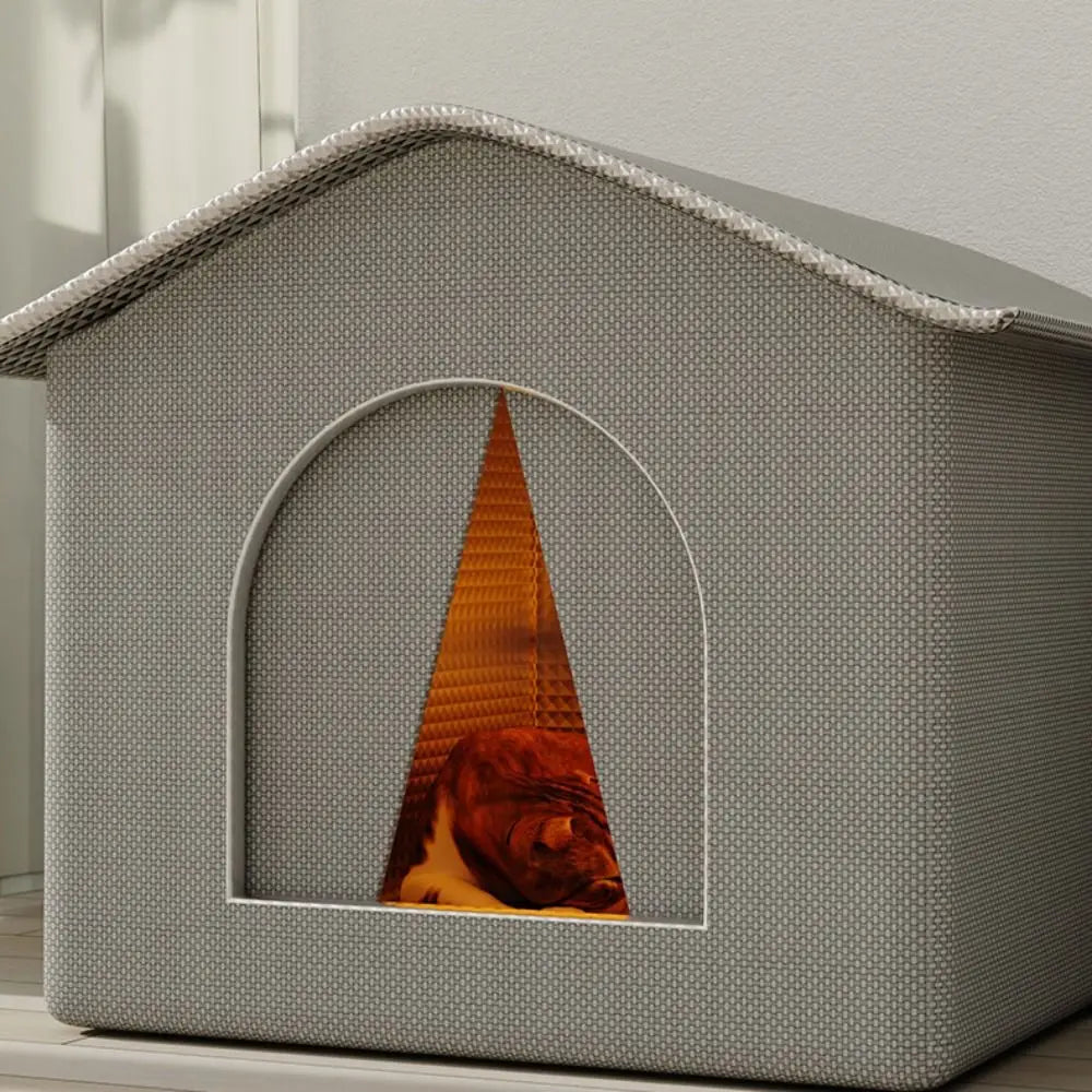 A gray foldable waterproof insulated cat house featuring a triangular thermal lining inside.
