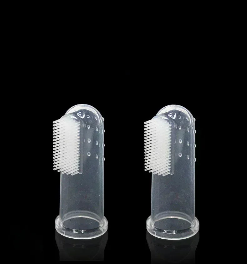 A clear silicone finger toothbrush for dogs shown against a black background.