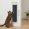 A tabby cat is climbing a cylindrical scratching post mounted on a white wall.