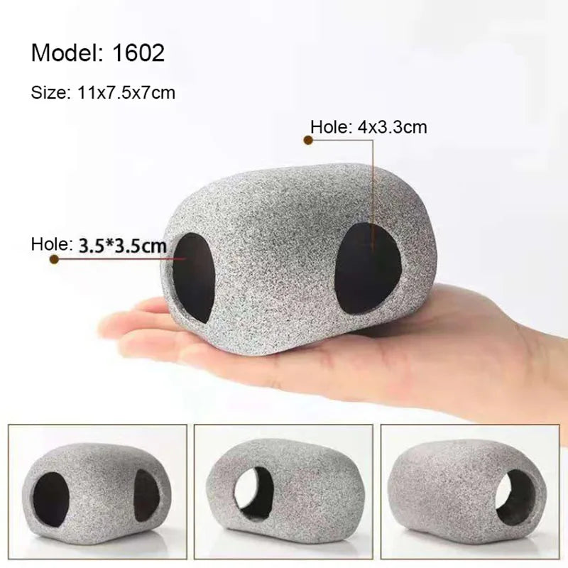 A hand holds a gray ceramic cichlid cave aquarium decor piece with round holes.