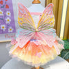 A colorful rainbow butterfly pet dress for cats and dogs featuring pink, yellow, and green sheer fabric.