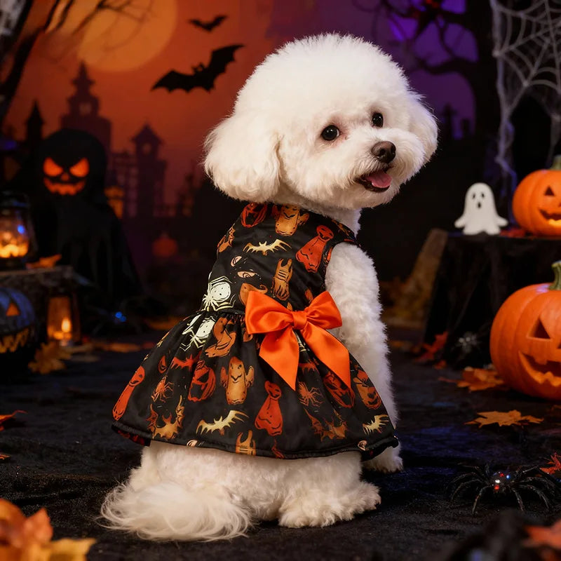 A white poodle wearing a black and orange Halloween princess dress with an orange bow, set against a spooky backdrop.