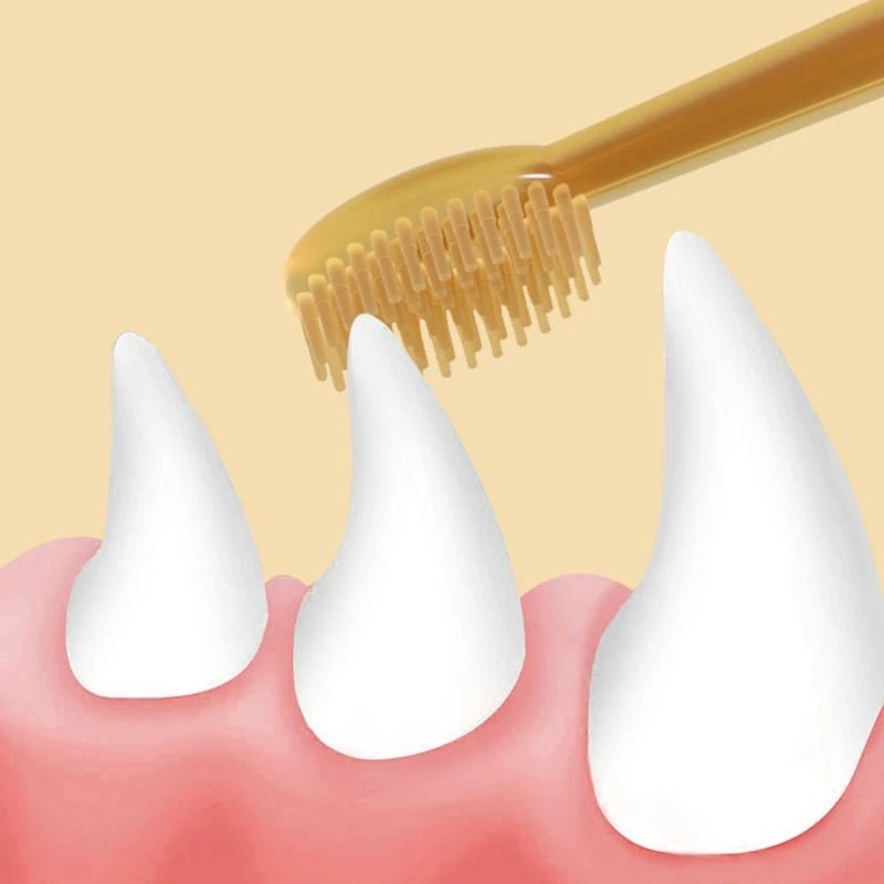 A golden silicone pet toothbrush is shown brushing a white tooth on a pink tongue.