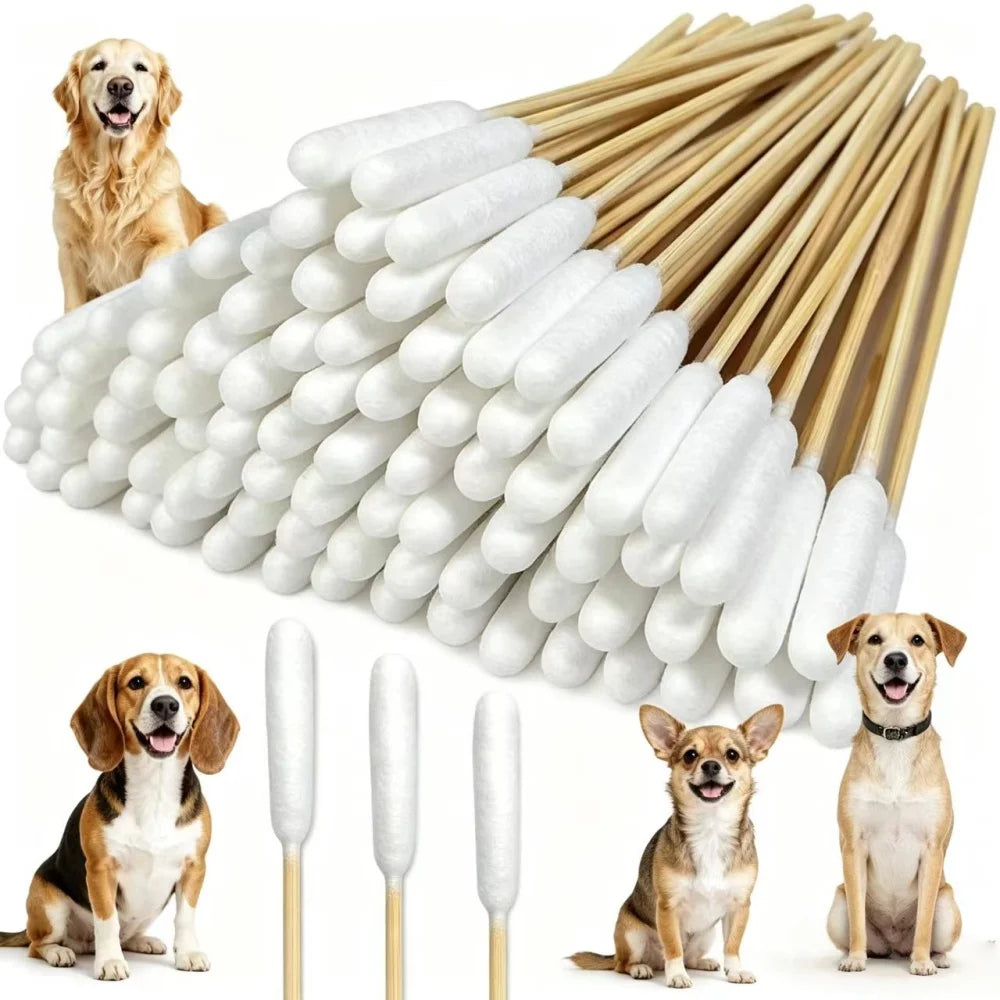 A bundle of long white cotton swabs with small white balls for pet ear cleaning next to several dogs.
