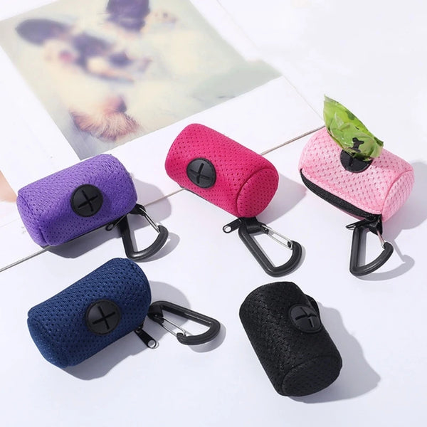 A collection of colorful pet waste bag dispensers in various colors and a black dispenser with a leash clip.